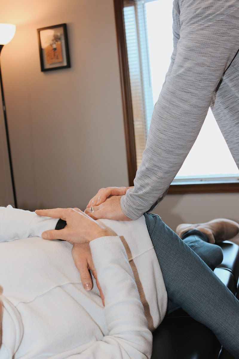 Close-up of a chiropractic adjustment on a patient's leg